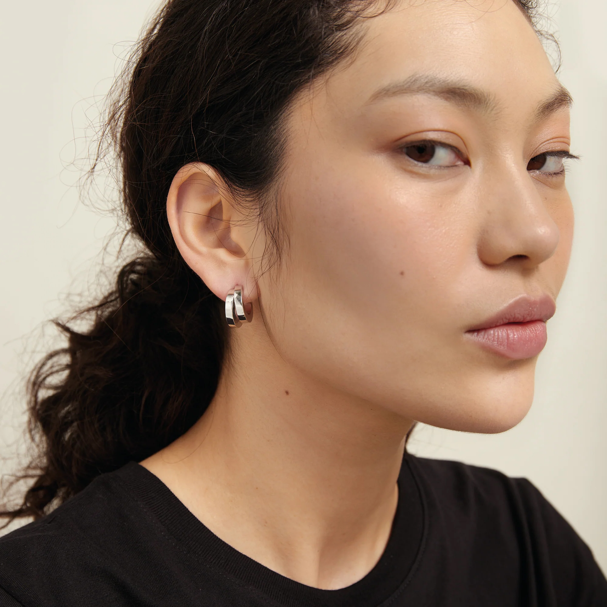 A model wearing Monarc Jewelly earrings
