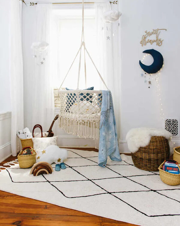 A childs bedroom with a Lorena Canals rug in the middle.