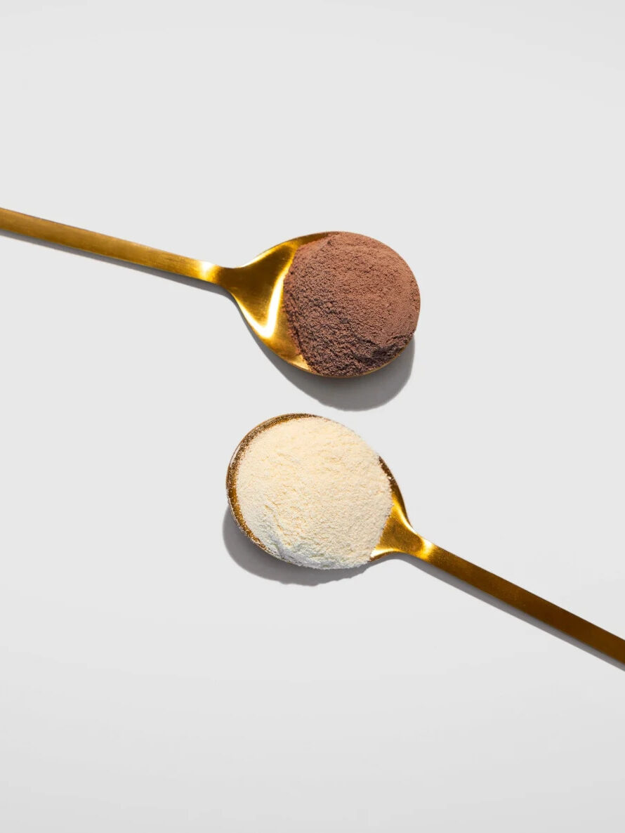 Two spoons next to each other, with mindbodygreen collagen in each. 