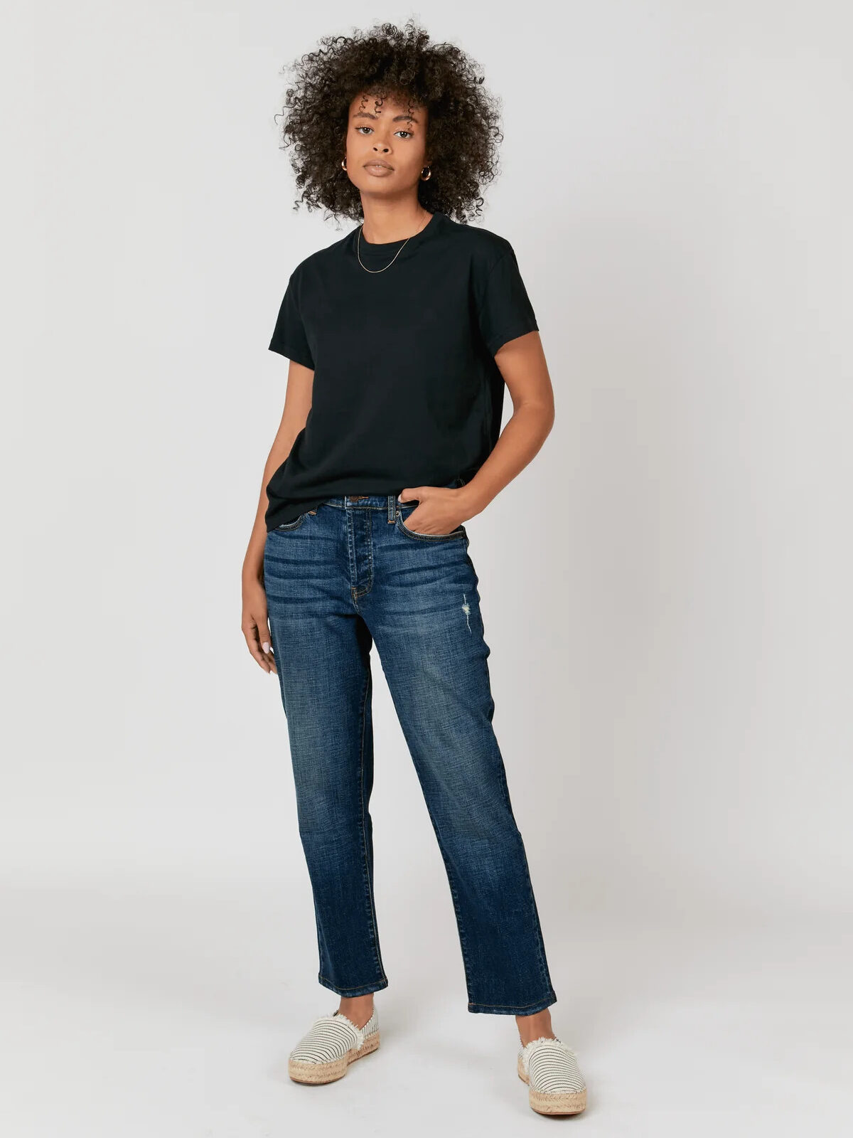 A model wearing sustainable Oliver Logan jeans.