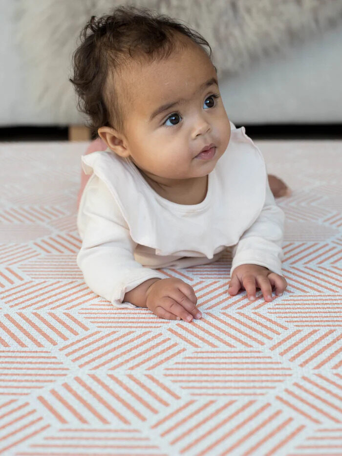 A baby on a Totter + Tumblr rug. 