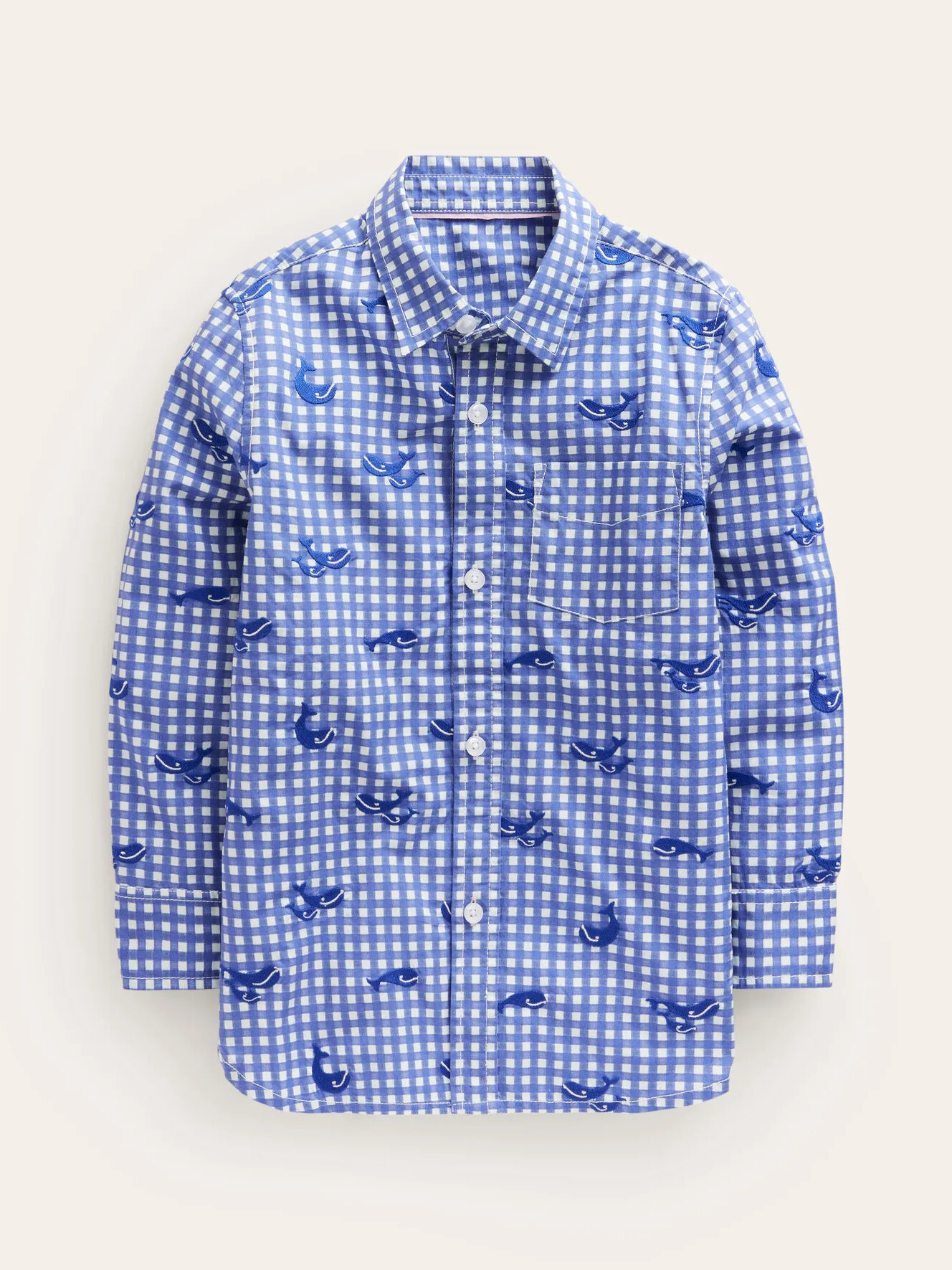 A blue shirt with white and blue birds on it.