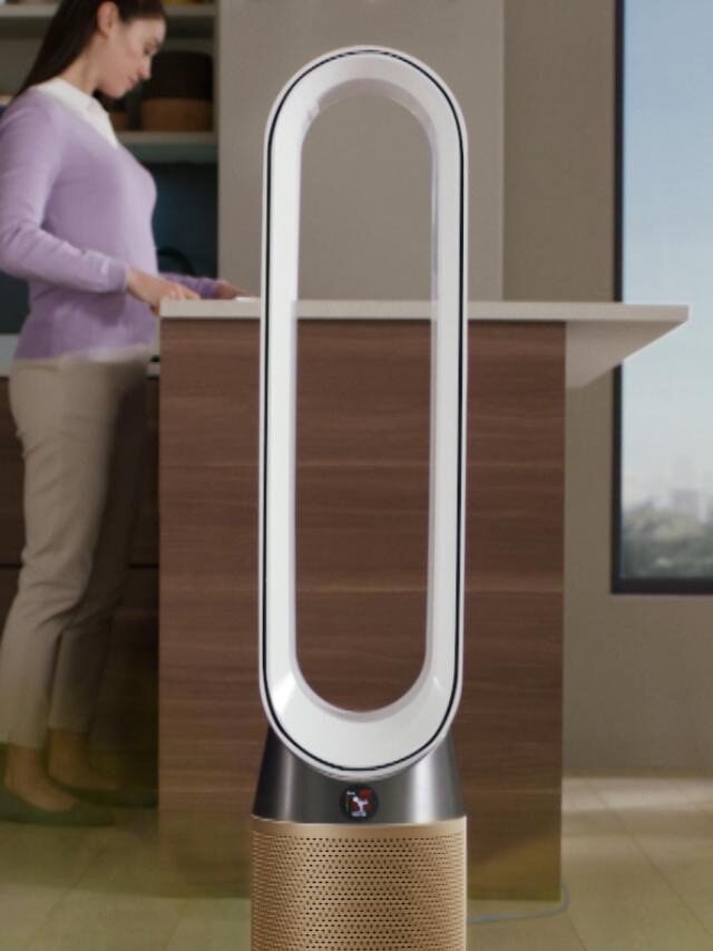 A Dyson Air Purifier standing in a modern room with a woman in the background.