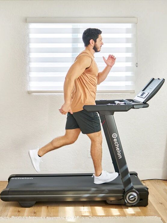 Man exercising on a treadmill at home.