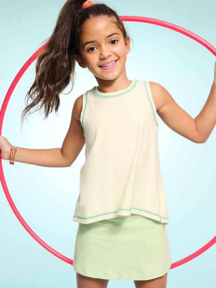 A young girl holding a hula hoop.