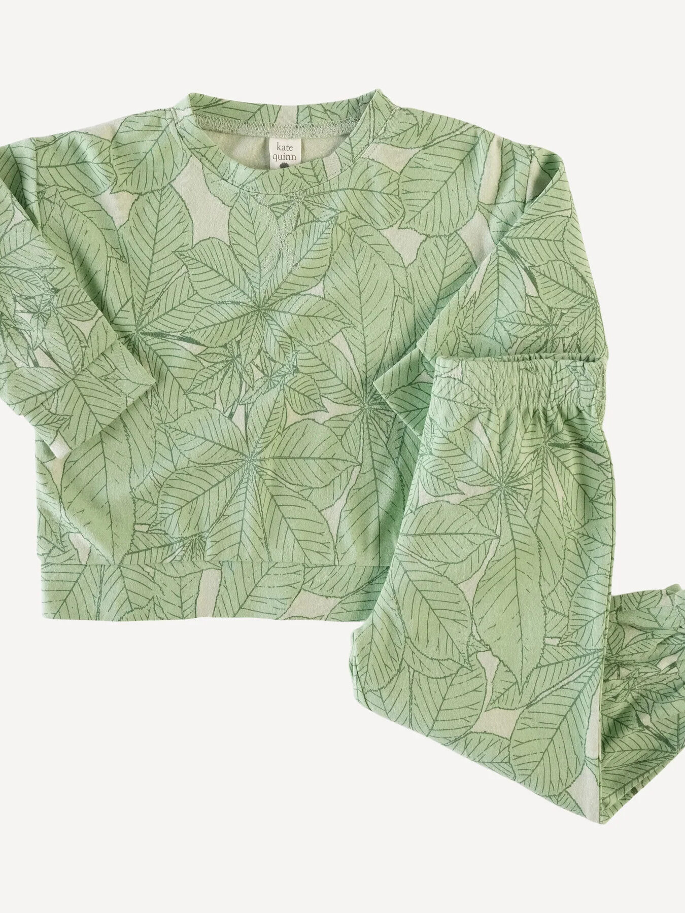A green leaf print pajama set for a baby.