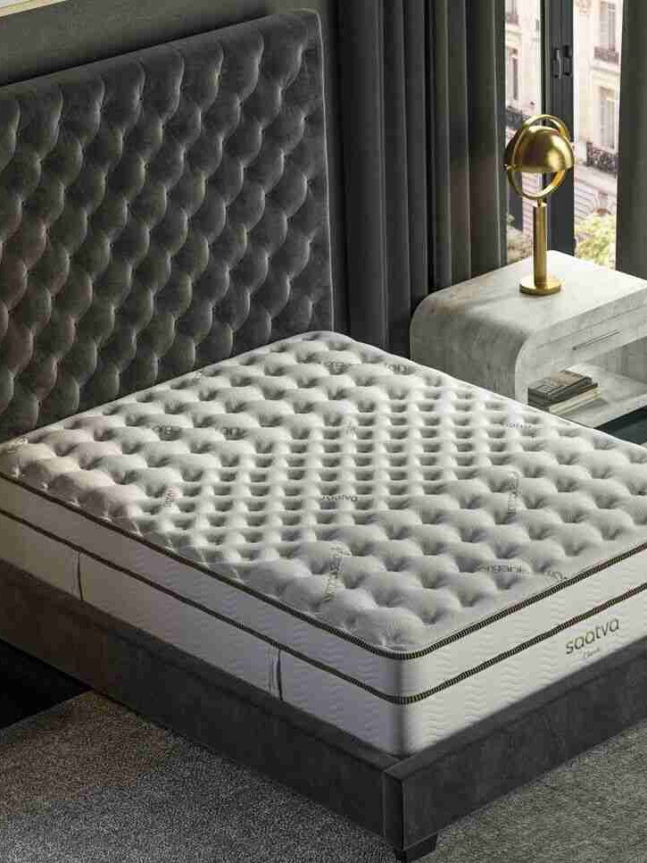 A Saatva mattress on a bedframe.