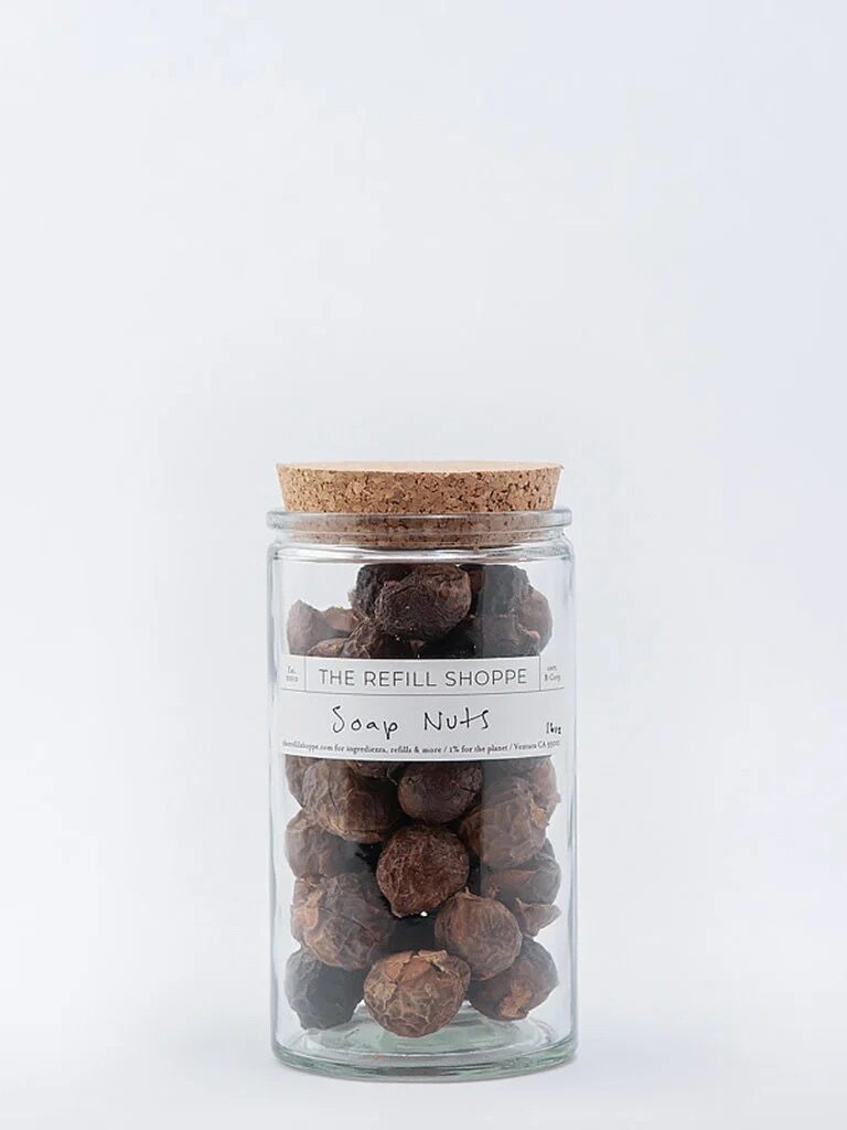 Glass jar filled with soap nuts and labeled 
