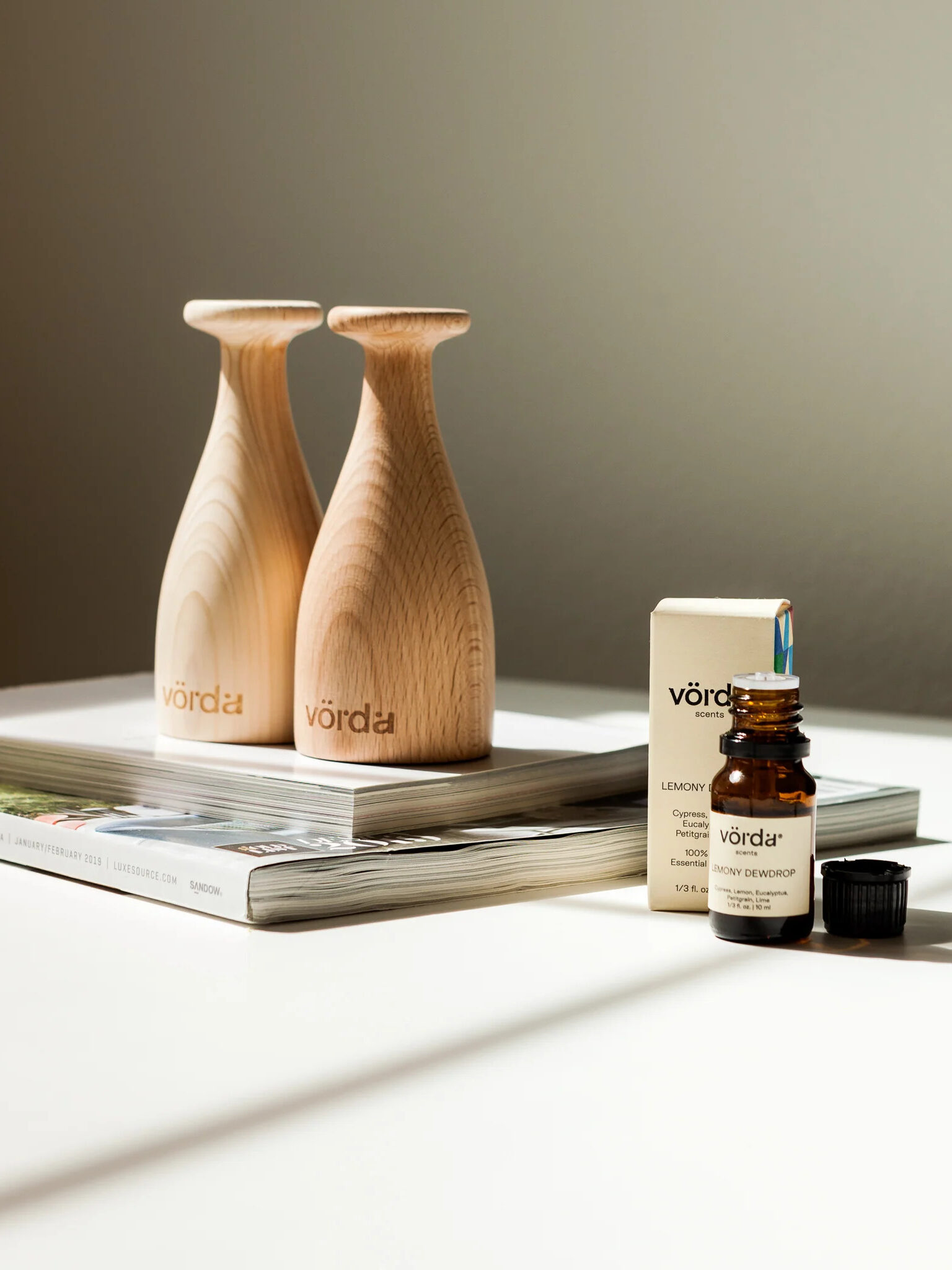 Two Vorda Wooden Diffusers next to a Vorda essential oil.