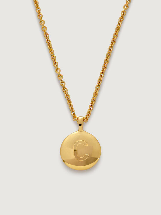 Gold pendant with the letter "c" on a matching chain.