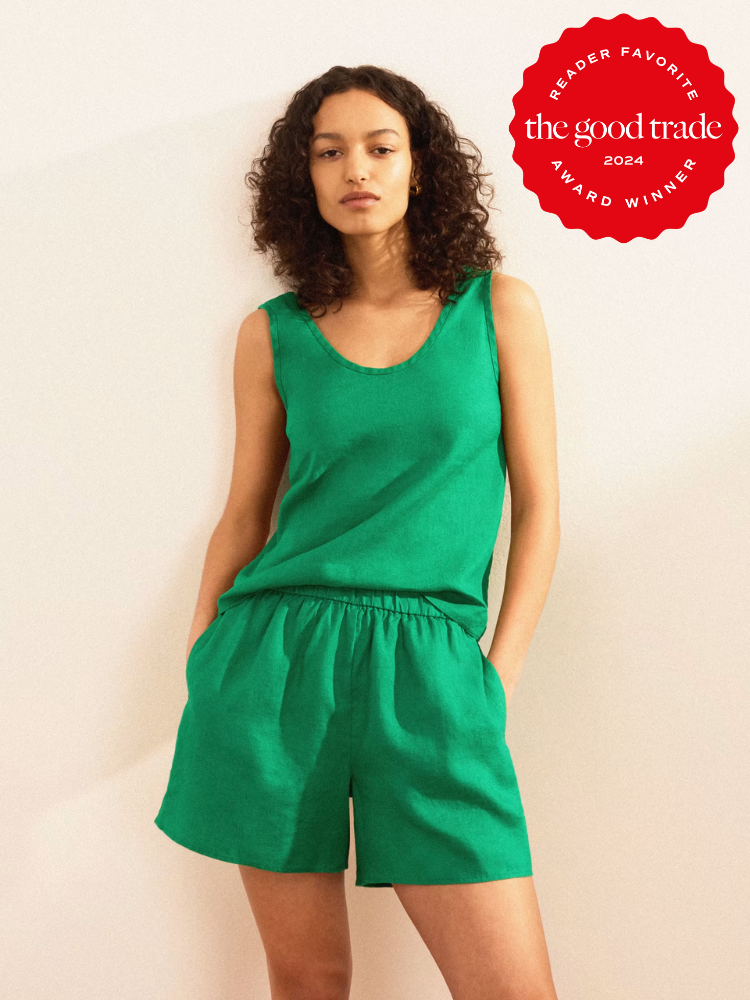 Woman standing in a neutral pose, wearing a green sleeveless top and matching shorts, with text indicating a "reader favorite wardrobe 2024" award.