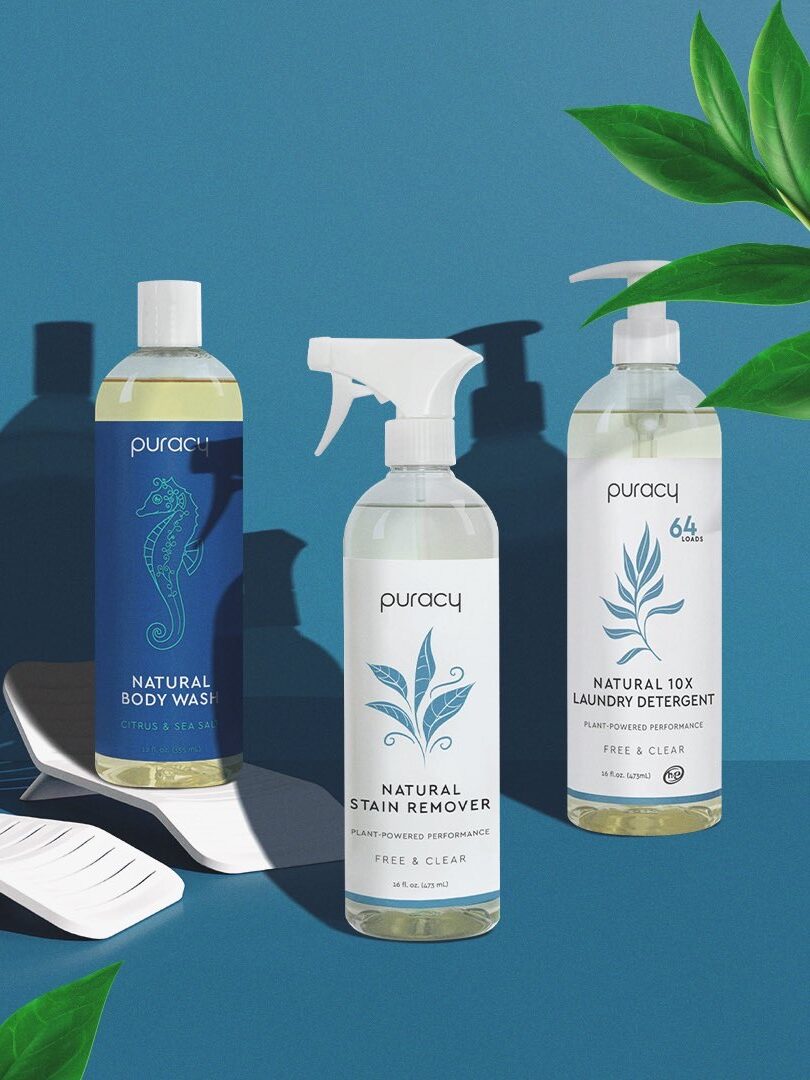 A collection of puracy natural cleaning and personal care products displayed with plant elements on a blue background.
