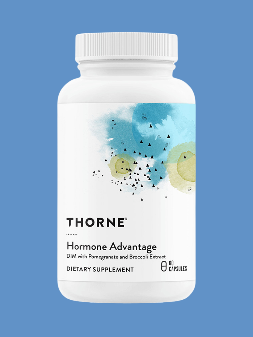 A white supplement bottle labeled "thorne hormone advantage" with watercolor design, featuring pomegranate and broccoli extract, against a blue background.