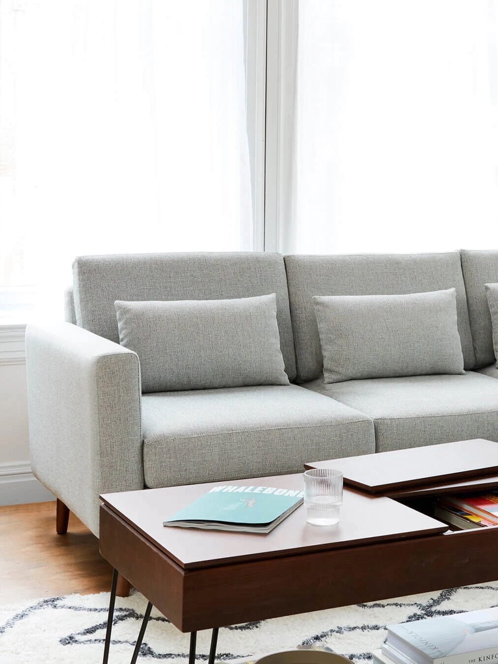 A light grey burrow couch in a living room setting. 