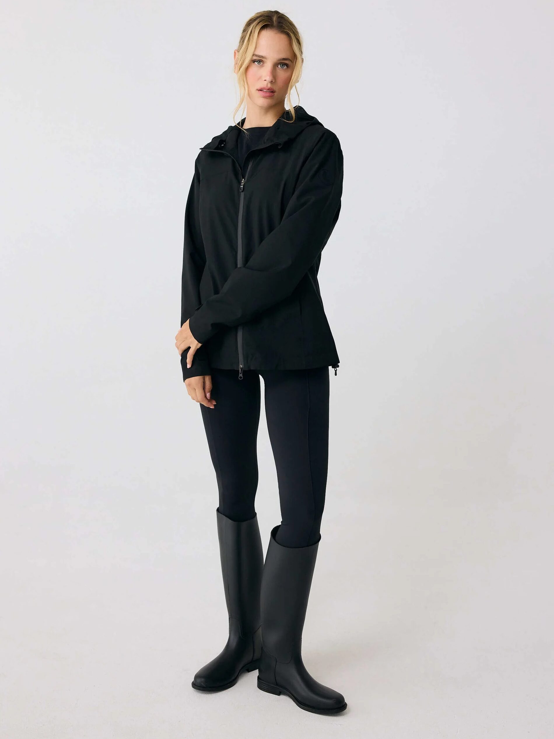 A model wearing a black Lole rain jacket. 