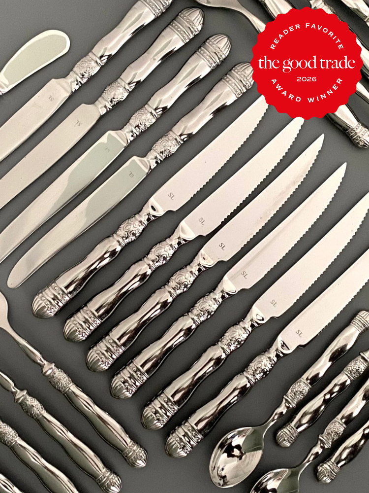 A set of ornate silver cutlery, including knives, forks, and spoons, arranged neatly on a gray surface. A red "Reader Favorite" award badge is in the top right corner.