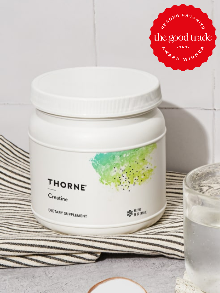 A container of Thorne Creatine dietary supplement sits on a striped cloth, with a red "The Good Trade Award Winner 2026" badge in the top right corner.