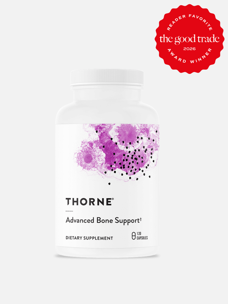 A white bottle of Thorne Advanced Bone Support dietary supplement with purple abstract design, containing 180 capsules. A red “Reader Favorite” award badge is in the top right corner.