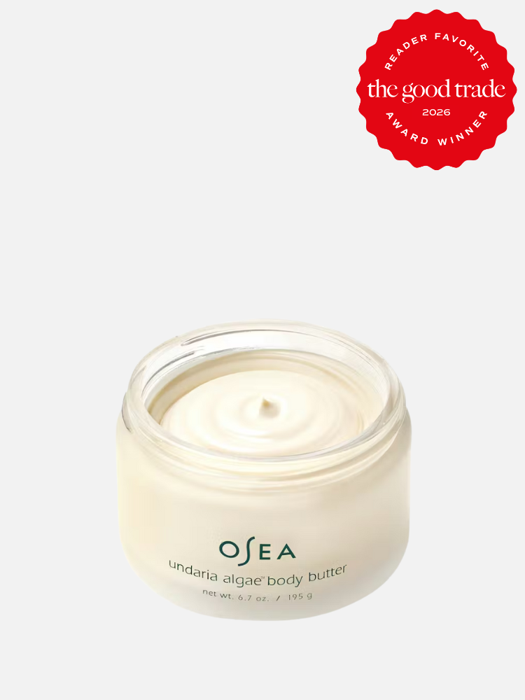 A jar of OSEA undaria algae body butter with an open lid, showing the cream inside. A red badge in the corner reads "The Good Trade Reader Favorite Award Winner 2026.