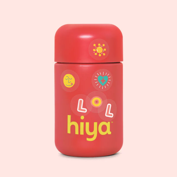 A red bottle with a rounded cap, featuring the word "hiya" in yellow text and several colorful, playful stickers on the front.