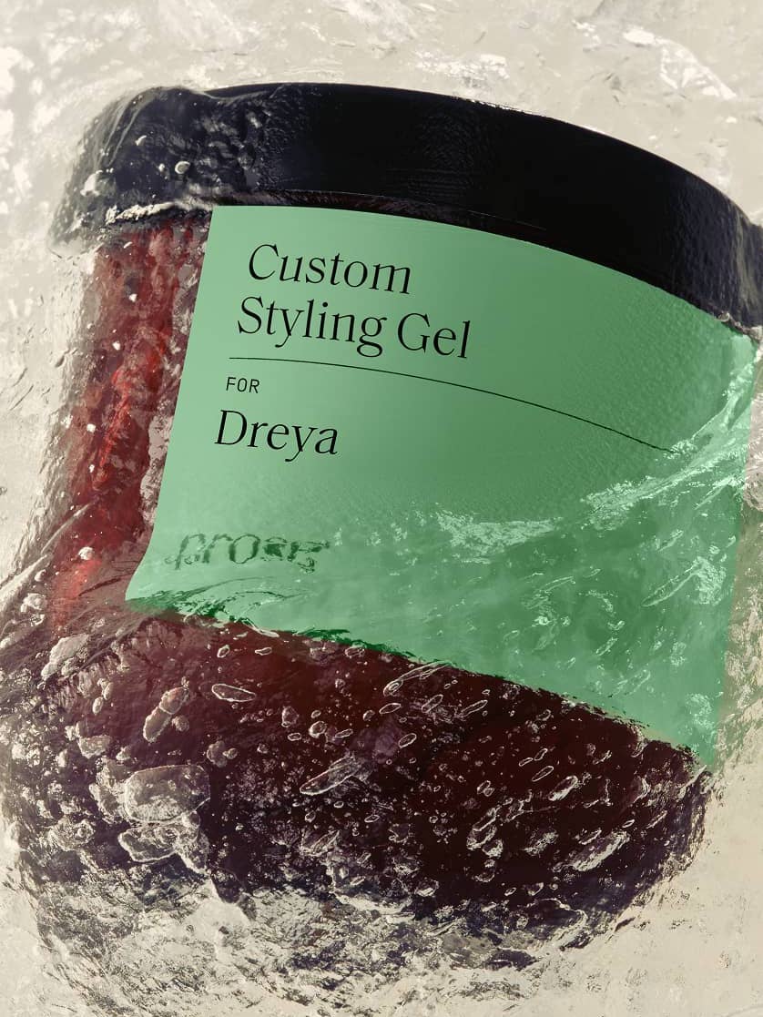 A jar labeled "Custom Styling Gel for Dreya" is partially submerged in swirling water.