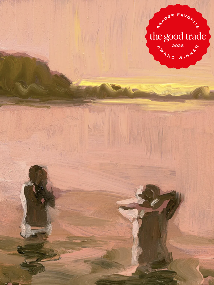 Two figures stand in shallow water at sunset with a forested shoreline in the background. A red "The Good Trade 2026 Reader Favorite Award Winner" badge is in the upper right corner.