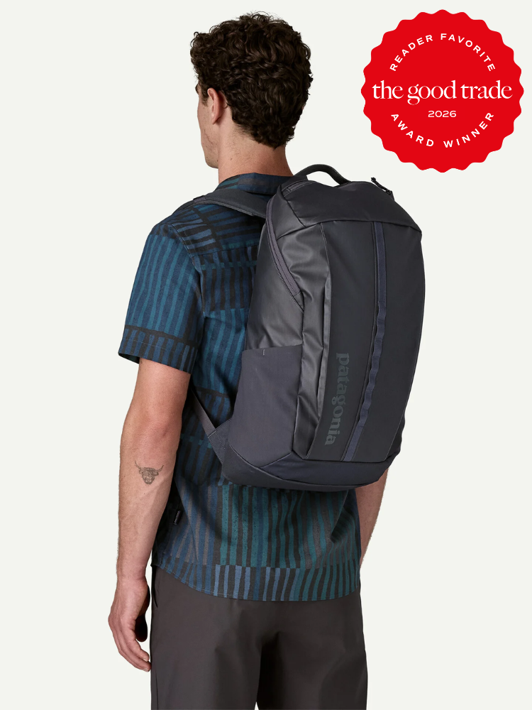 A man wearing a short-sleeve patterned shirt carries a dark Patagonia backpack. A red badge in the corner reads “The Good Trade 2026 Award Winner.”.