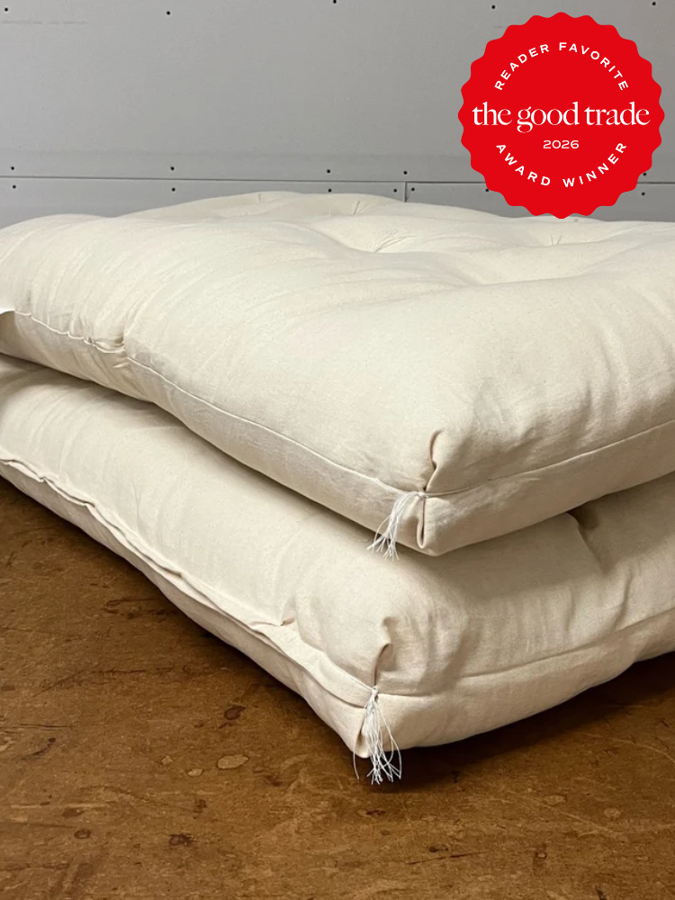 A stack of pillows on a wood surface.