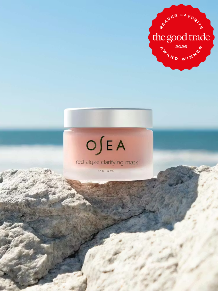 A jar of OSEA red algae clarifying mask sits on a rock by the ocean, with a "The Good Trade 2026 Reader Favorite Award Winner" badge in the corner.