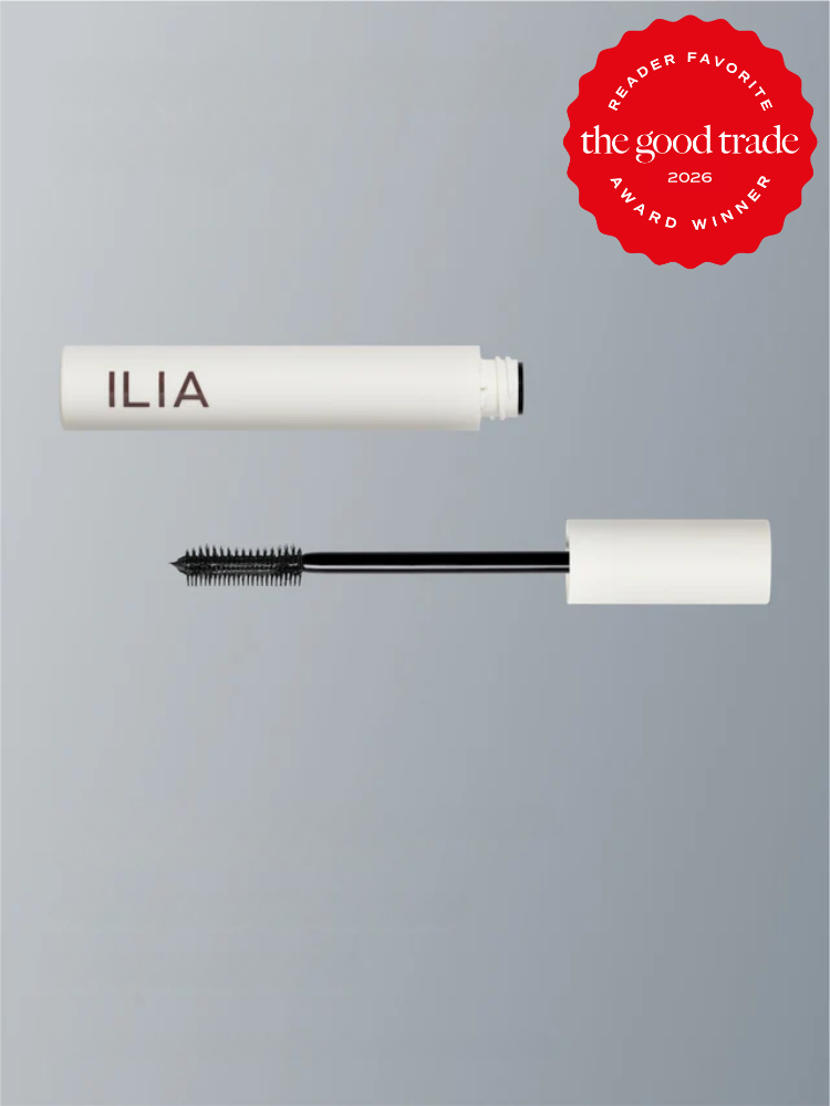 A white ILIA mascara tube and wand on a gray background, with a red "The Good Trade Reader Favorite Award Winner 2026" badge in the top right corner.