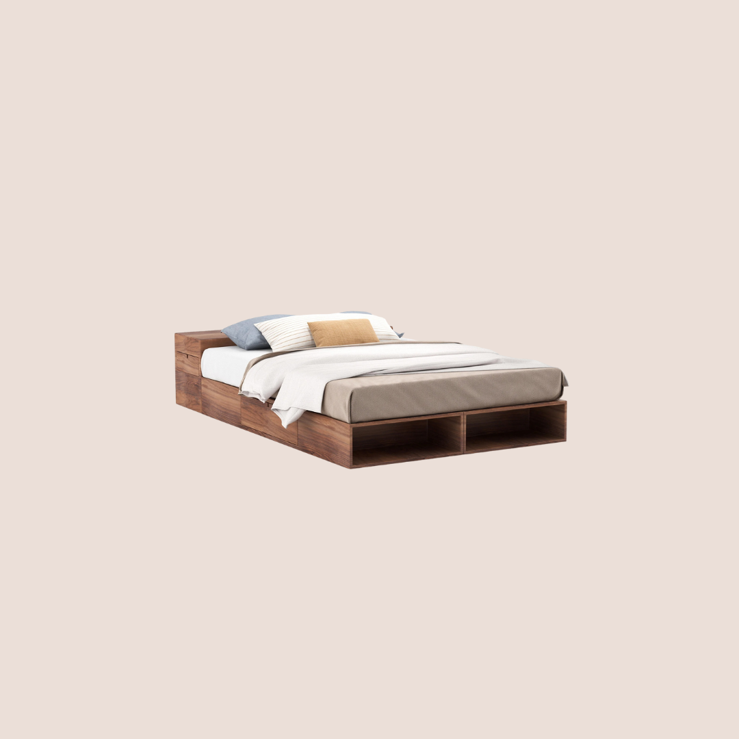 A wooden bed with built-in storage compartments, neatly made with white and beige bedding and several pillows, set against a plain beige background.
