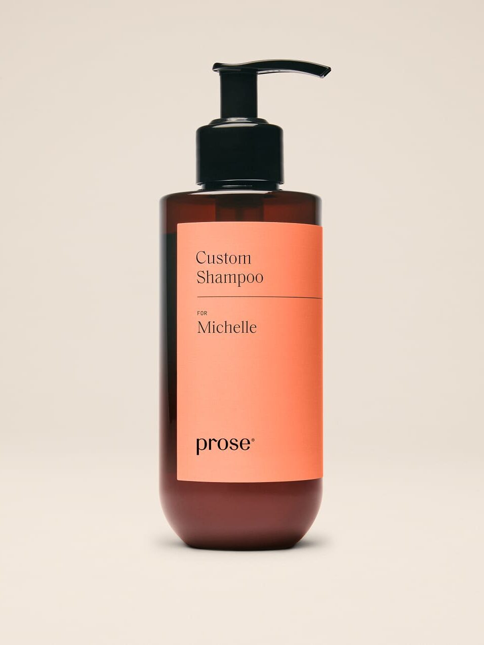 A brown bottle with a black pump labeled "Custom Shampoo for Michelle" by Prose, against a plain beige background.