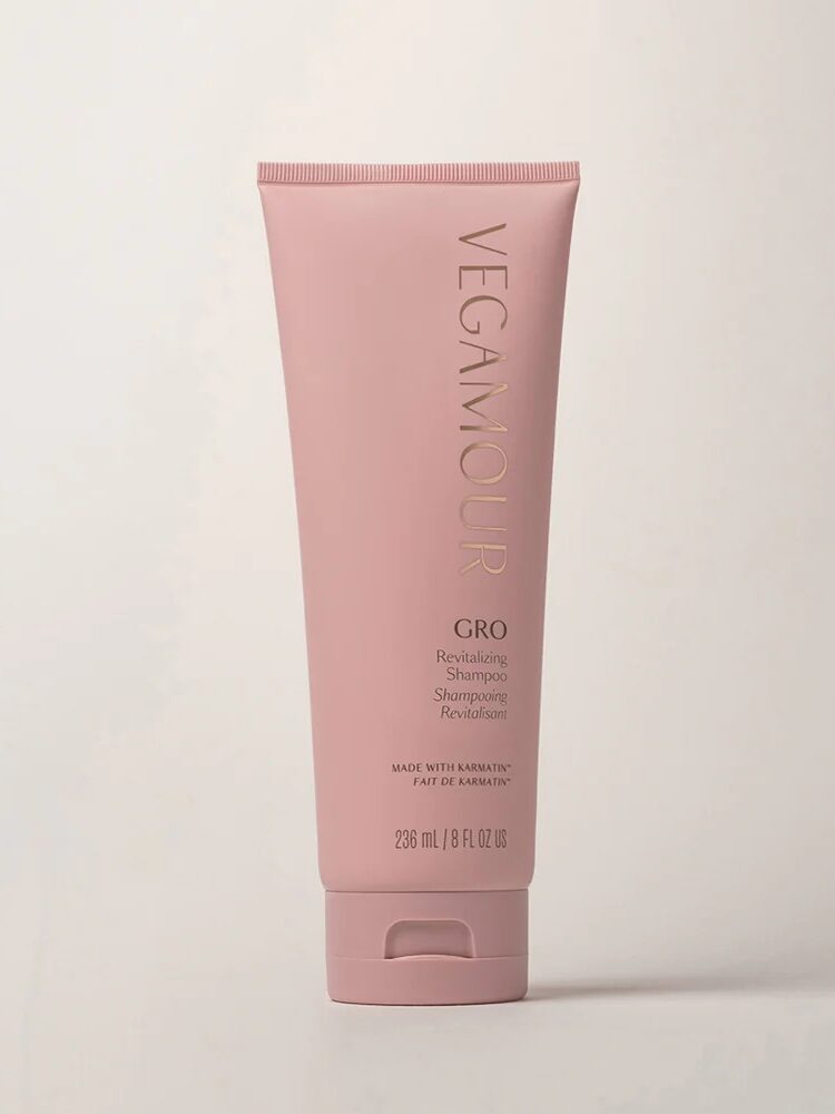 A pink tube of Vegamour GRO Revitalizing Shampoo, 236 ml (8 fl oz), standing upright against a plain light background.
