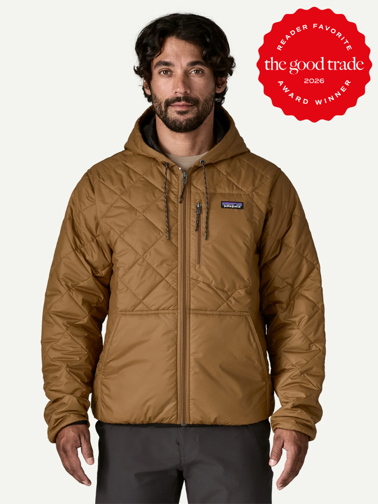 A man wearing a brown quilted hooded jacket stands facing forward. A red badge in the top right corner reads, "The Good Trade Reader Favorite Award Winner 2026.