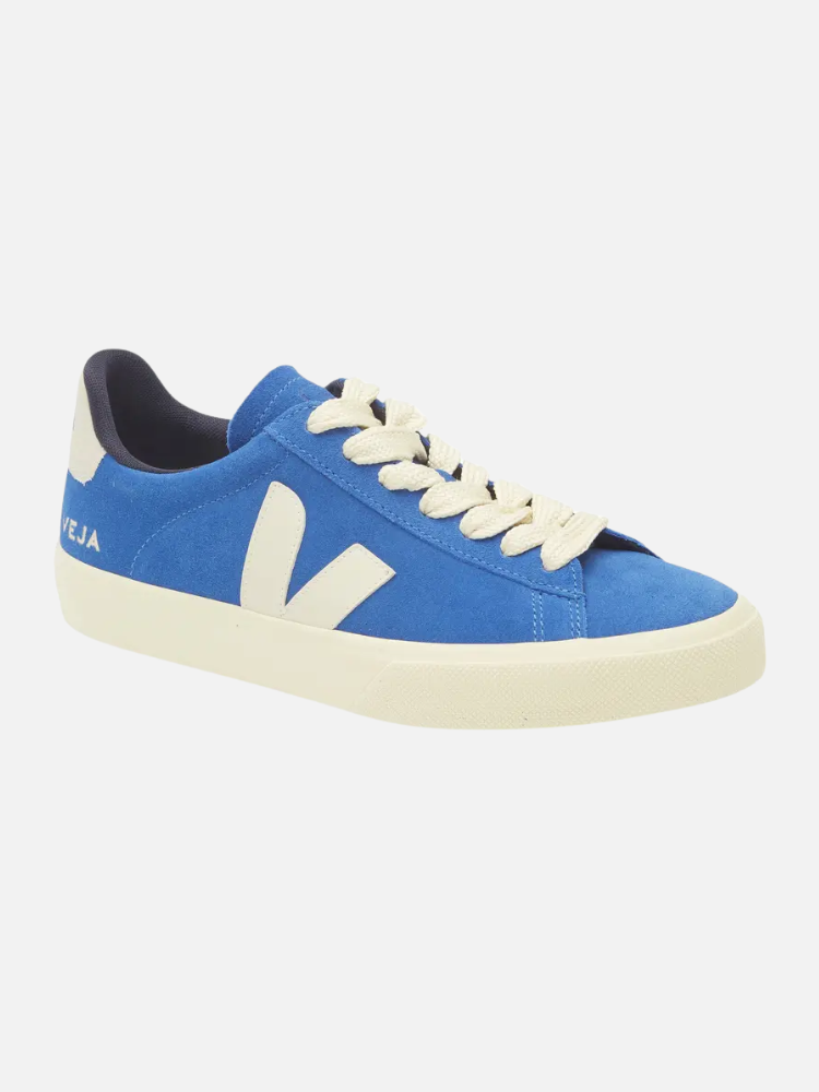 A blue Veja sustainable sneaker with white laces, a white side logo, and an off-white sole is shown against a plain background.