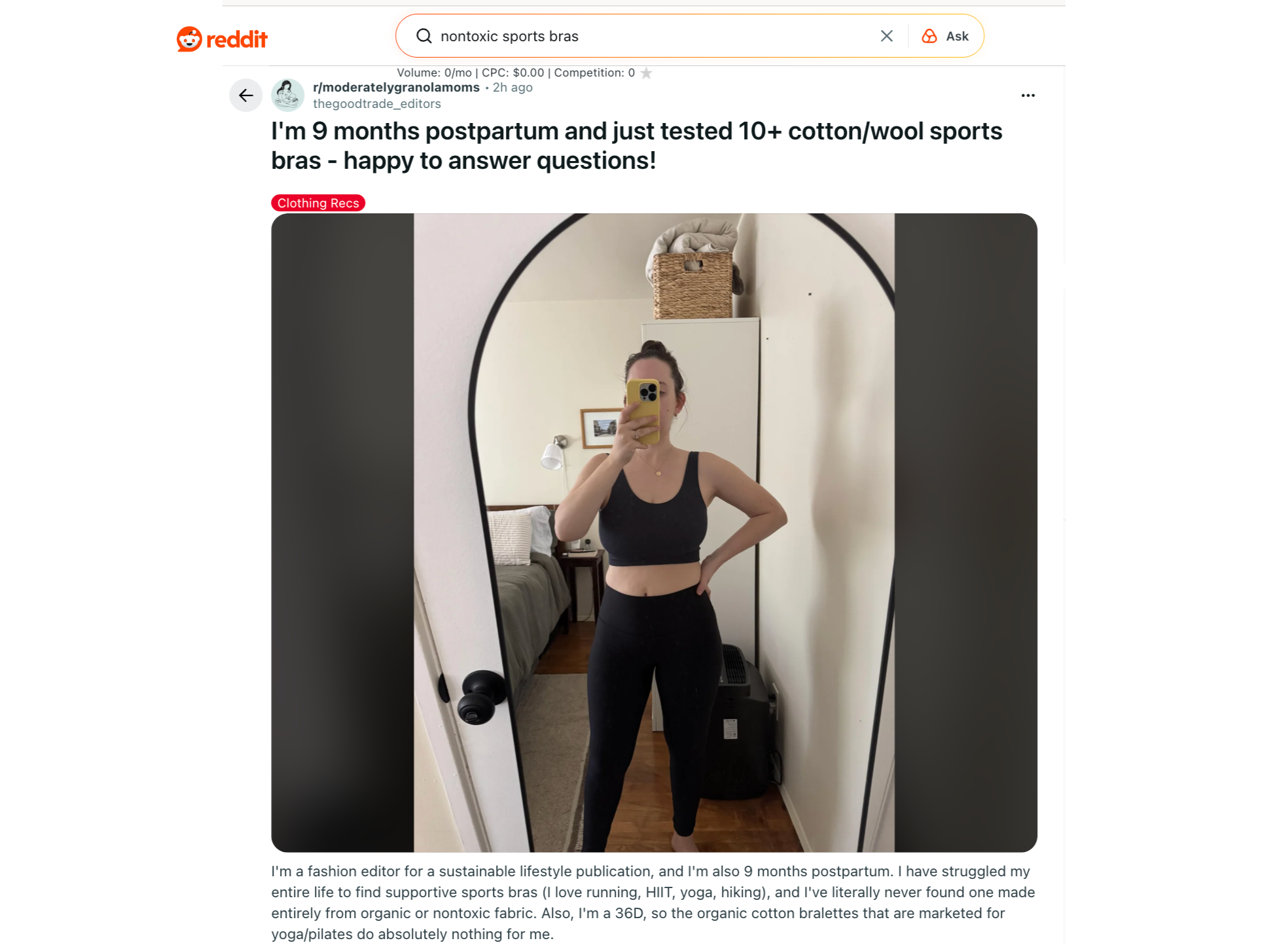 A woman stands in front of a mirror taking a selfie, wearing a black sports bra and black leggings, with text above about testing sports bras postpartum.