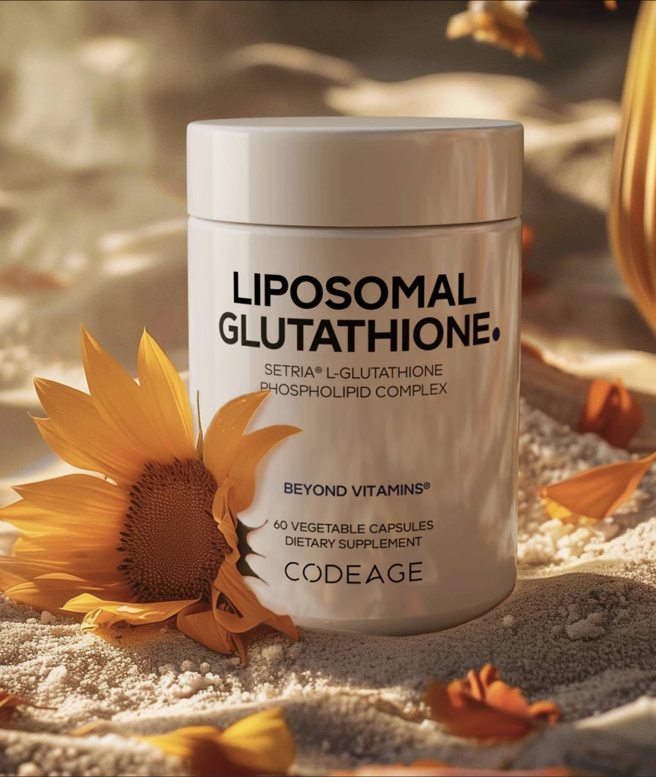 A container of Codeage Liposomal Glutathione dietary supplement sits on sand next to a yellow flower. The label highlights Setria L-glutathione and 60 vegetable capsules.