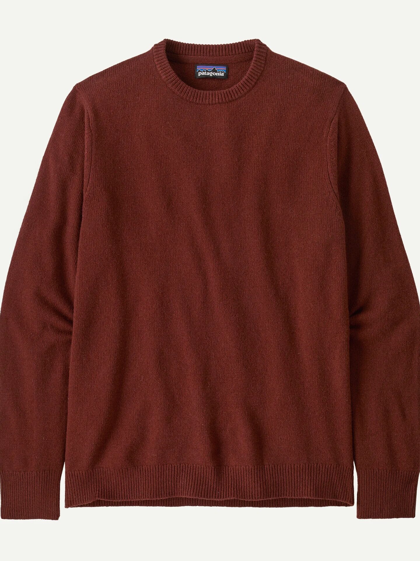 A plain long-sleeve crew neck sweater in a solid rust red color, displayed flat on a white background.