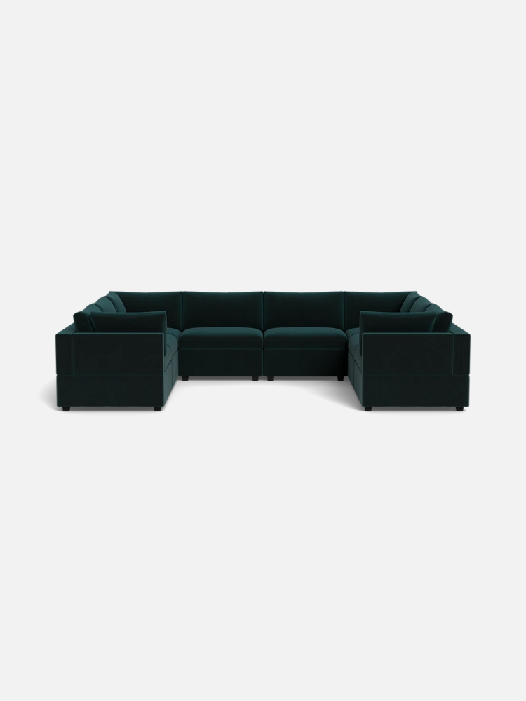 Dark green velvet sectional sofa with three segments arranged in a U-shape, set against a plain white background.