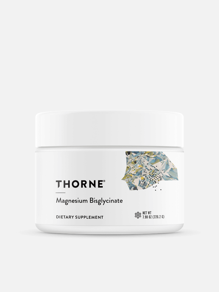 A white jar labeled "Thorne Magnesium Bisglycinate Dietary Supplement" with an abstract design on the label, photographed on a light background.