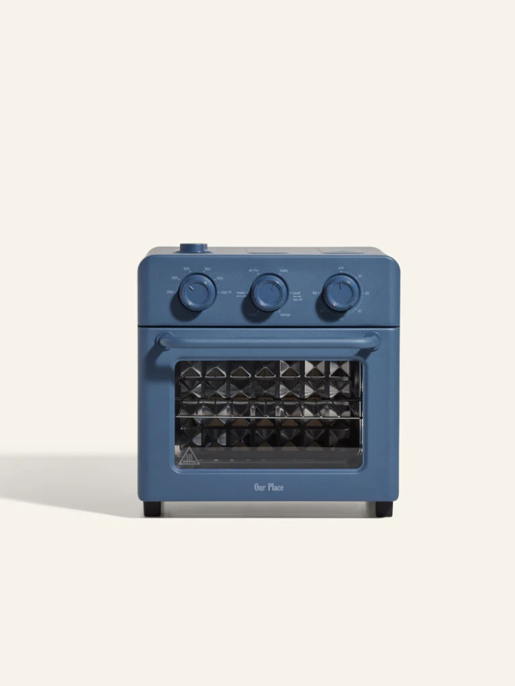 A blue countertop air fryer oven with three control dials and a glass door, shown against a plain light background.