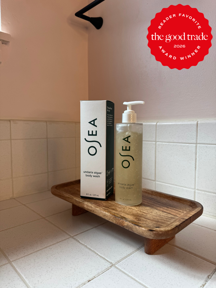 OSEA Undaria Algae Body Wash bottle and box on a wooden tray in a tiled bathroom, with a "The Good Trade 2026 Award Winner" badge in the corner.