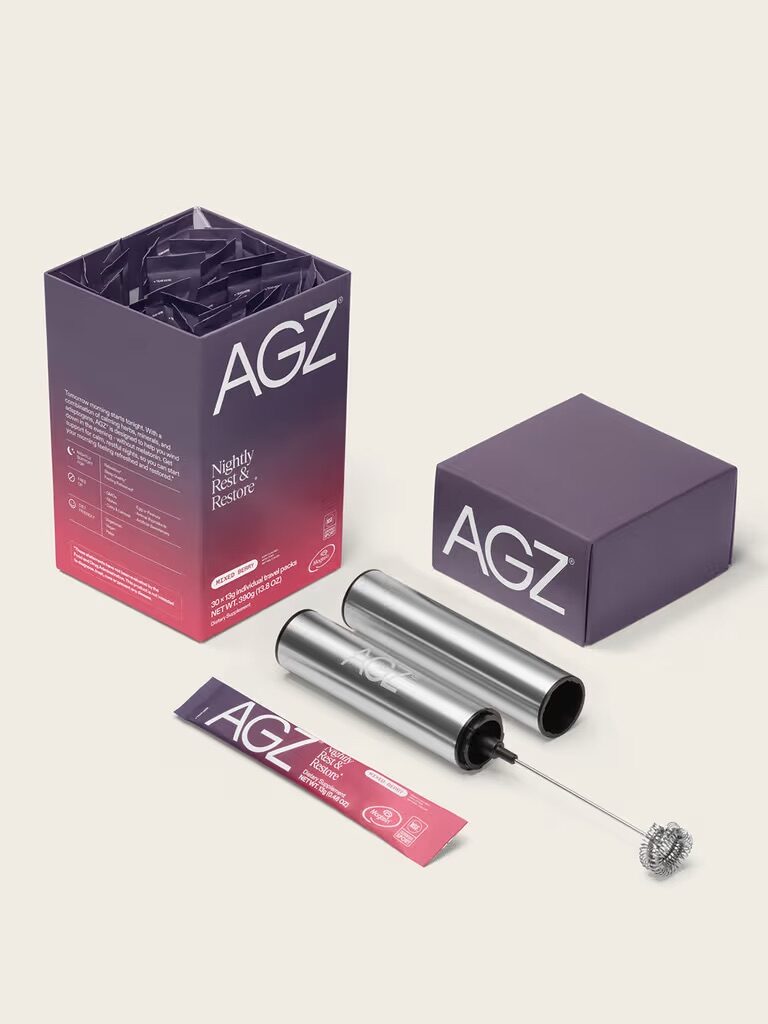 A box labeled "AGZ" with individual packets, a metallic cylindrical container, and a handheld frother displayed on a light background.