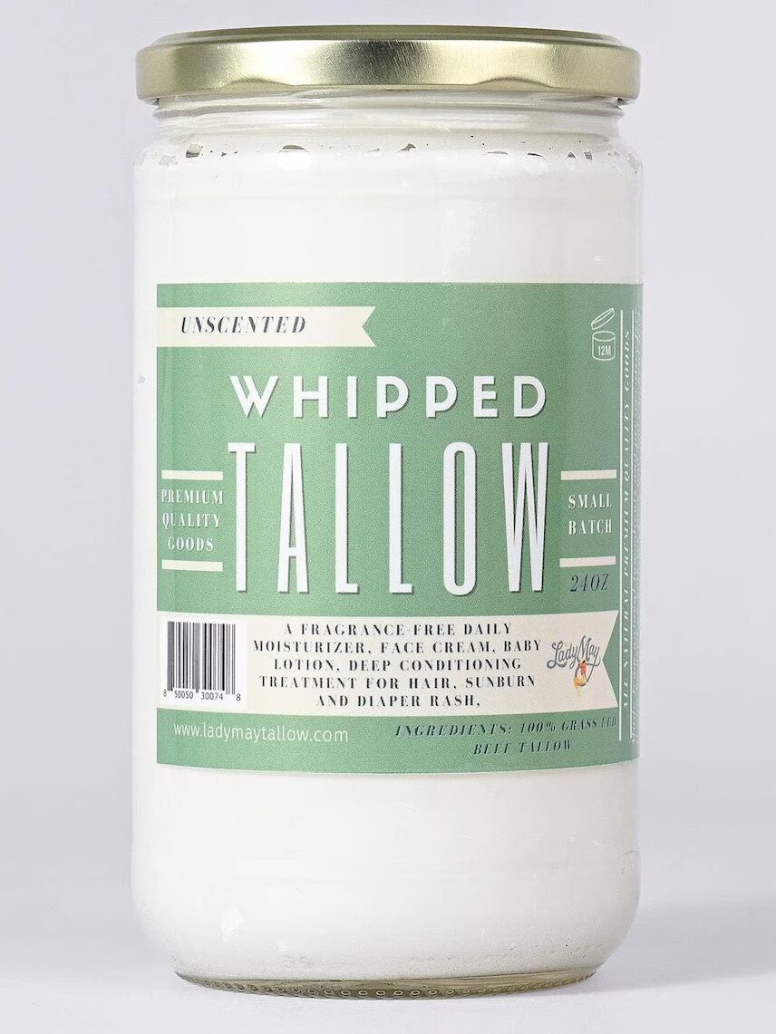 A jar of unscented whipped tallow with a green label, gold lid, and product details for moisturizing and skin care uses.