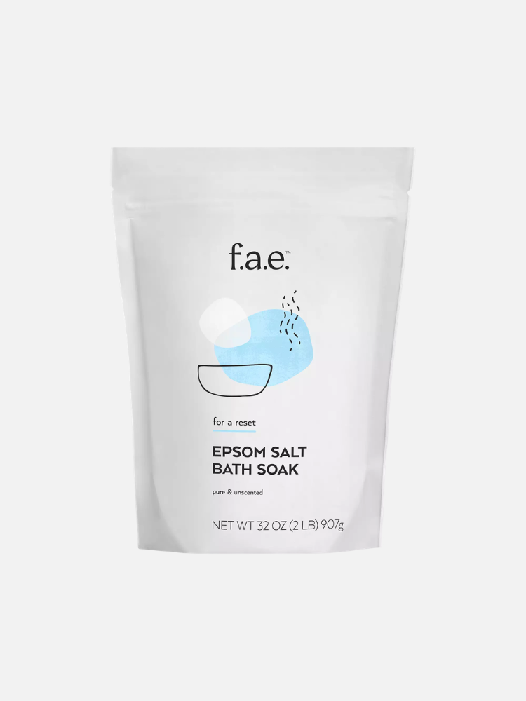 A white 32 oz bag of f.a.e. Epsom salt bath soak labeled "pure & unscented" with minimalist bowl illustration on the front.