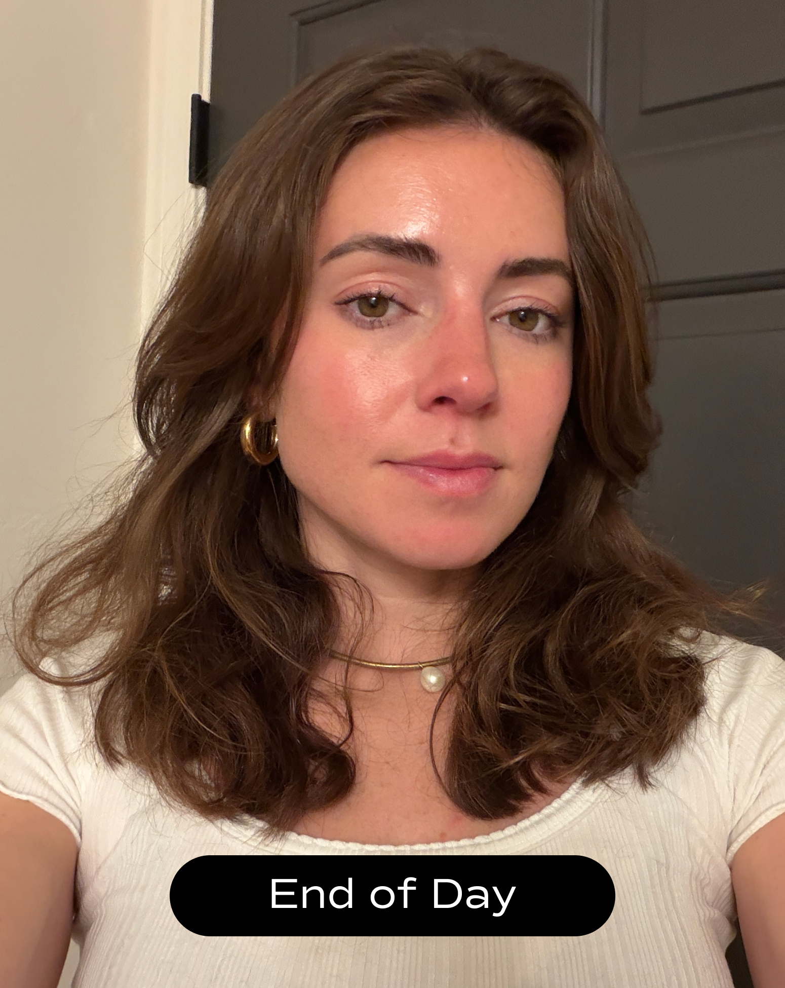 A woman with shoulder-length brown hair and a neutral expression stands indoors wearing a white top; the caption at the bottom reads "End of Day.