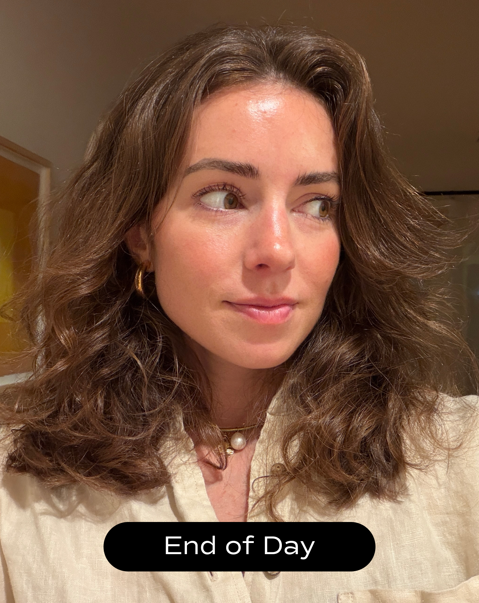 A woman with wavy brown hair and gold hoop earrings looks off to the side indoors. The text "End of Day" is displayed at the bottom.