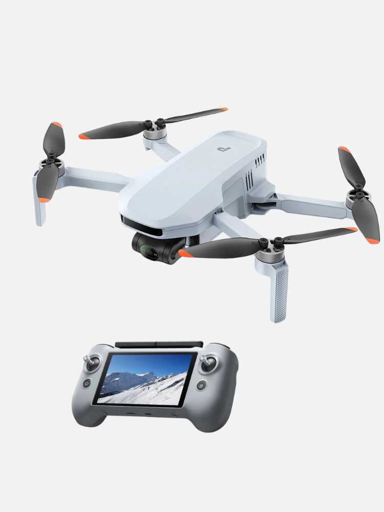 A white quadcopter drone with a camera is shown above a gray remote controller displaying a snowy mountain scene on its screen.