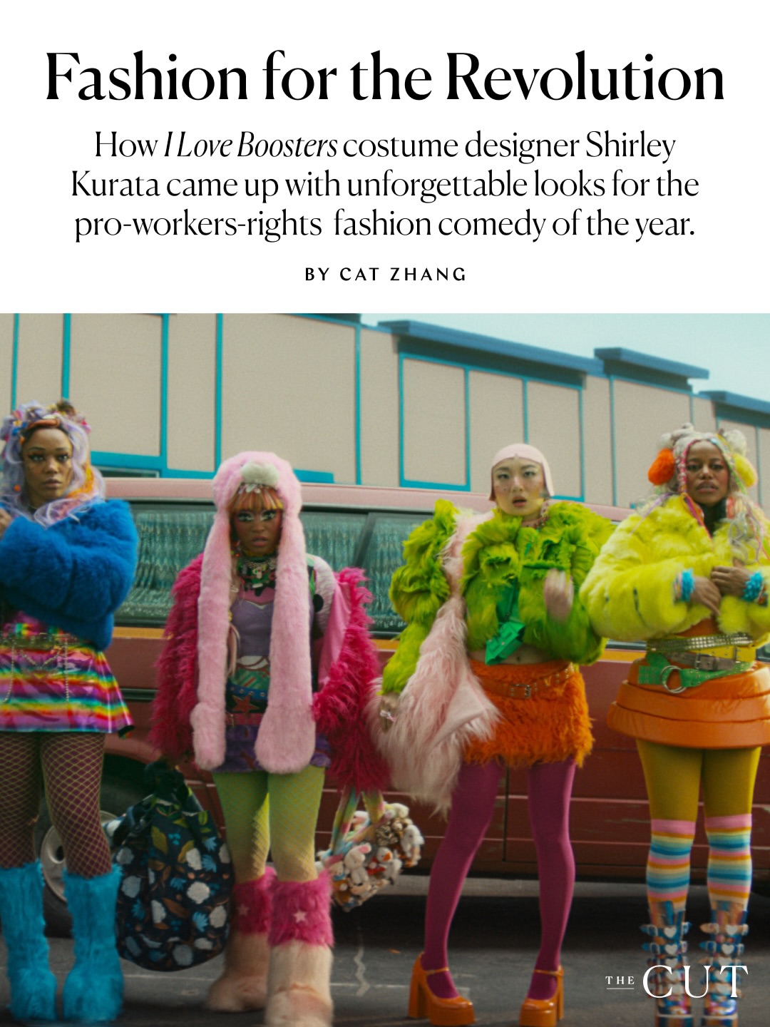 Four women wearing colorful, eccentric, and furry costumes stand in front of a red van in a parking lot.
