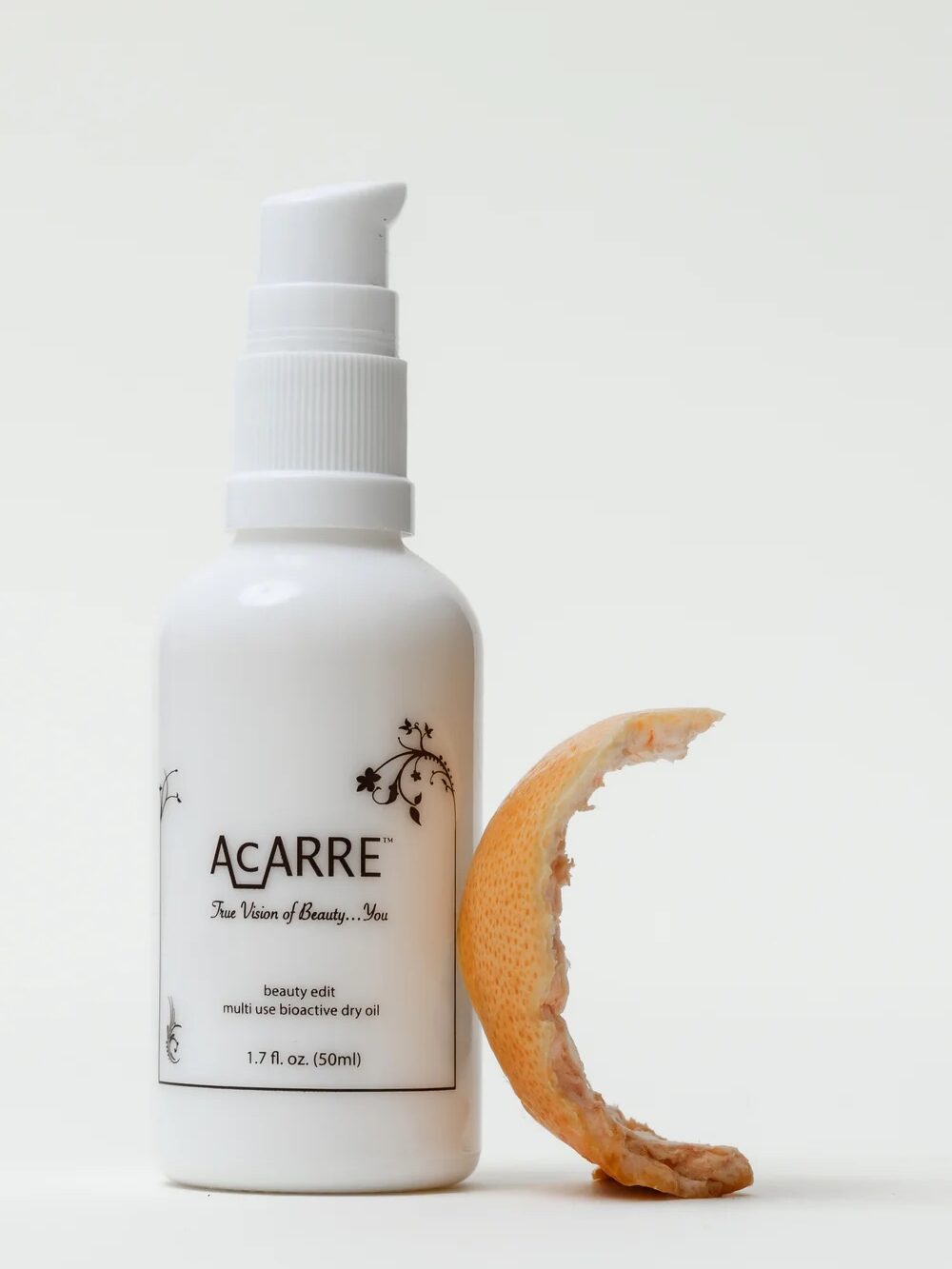 A white pump bottle labeled "Acarre" stands next to a partially peeled citrus rind on a plain, light background, evoking the fresh ease of online shopping.